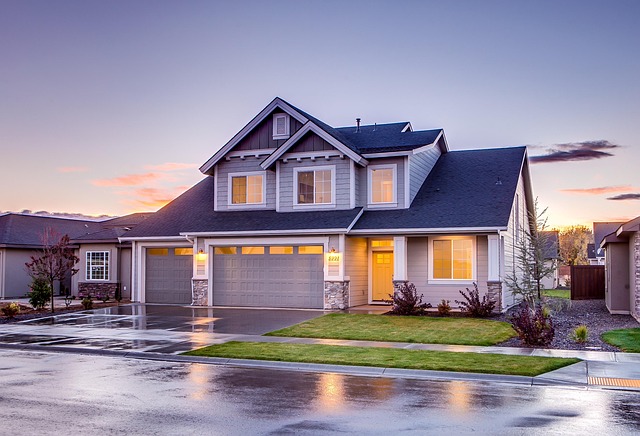 Modern%20two-story%20suburban%20house%20with%20gray%20siding,%20dark%20roof,%20and%20warm%20interior%20lights%20reflecting%20on%20wet%20pavement Modern two-story suburban house with gray siding, dark roof, and warm interior lights reflecting on wet pavement